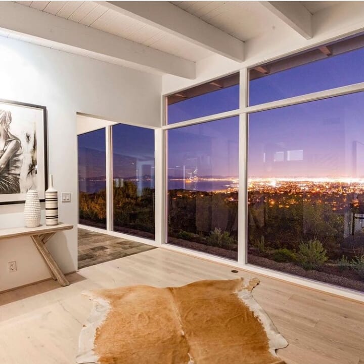 Realestate Valmonte, California, USA. Looking out from the living area through floor to ceiling windows over Valmonte, Santa Monica Bay, the Queen's Necklace and the Los Angeles city lights at night time.