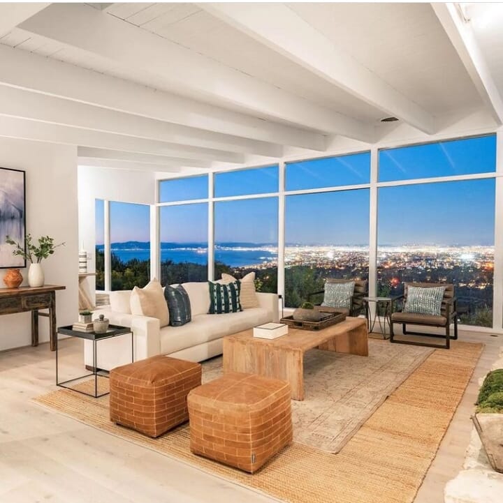 Realestate Valmonte, California, USA. View of the whole living area with exposed beams over looking L.A. and Santa Monica Bay area at night time.